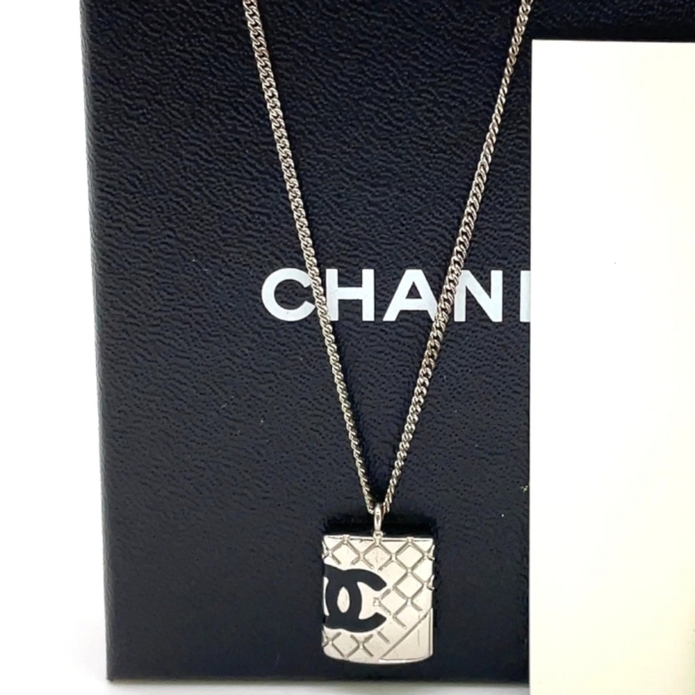CHANEL Silver Necklace with Black Logo Pendant
